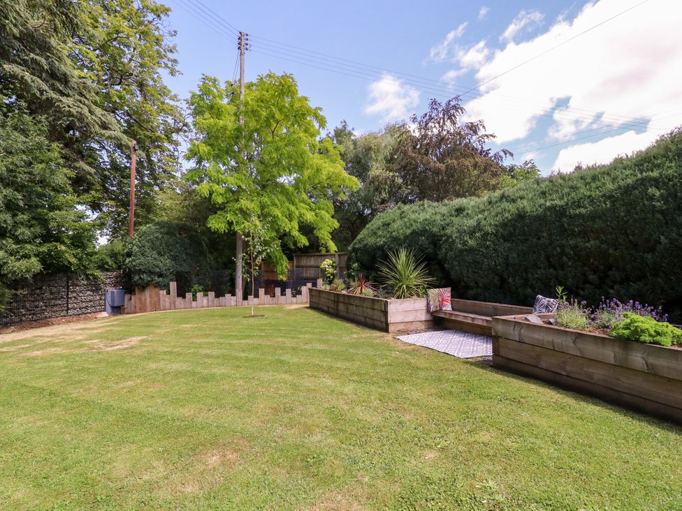 A garden with grass and trees at Thornbury in Barnard's Green, Malvern
