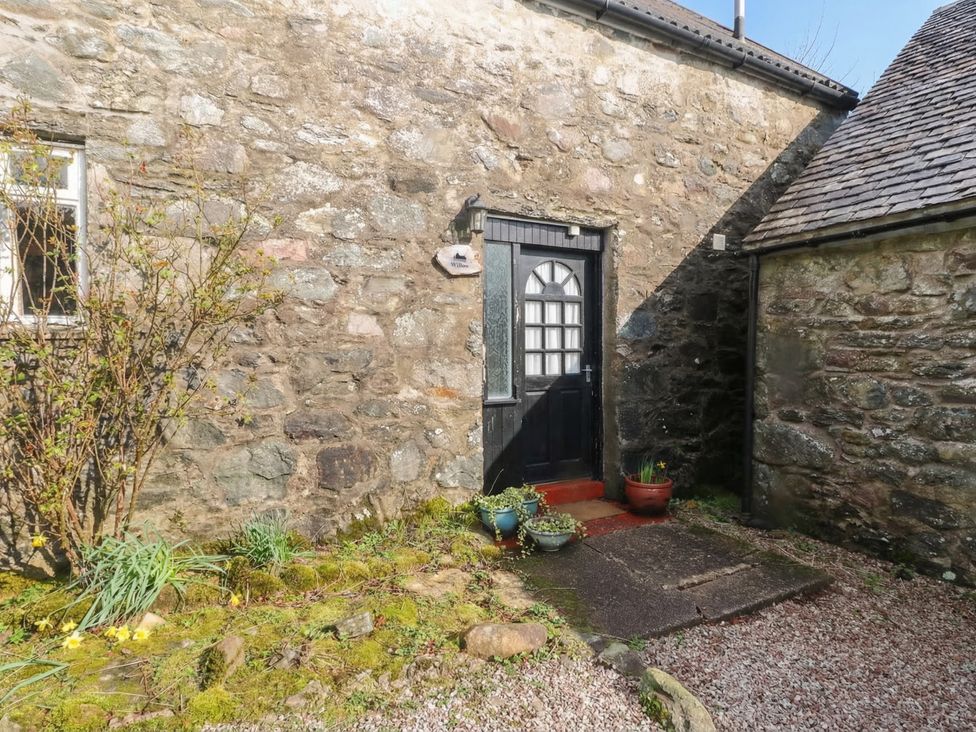 A stone wall with a door and window at Willow near Killean Farmhouse Cottages in Inveraray
