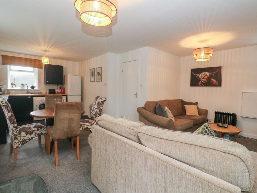 A living room and kitchen area with furniture at Willow Killean Farmhouse Cottages near Inveraray