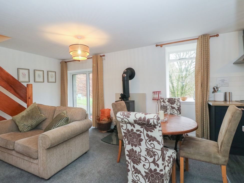 A living room with a sofa and dining table at Willow Killean Farmhouse Cottages near Inveraray