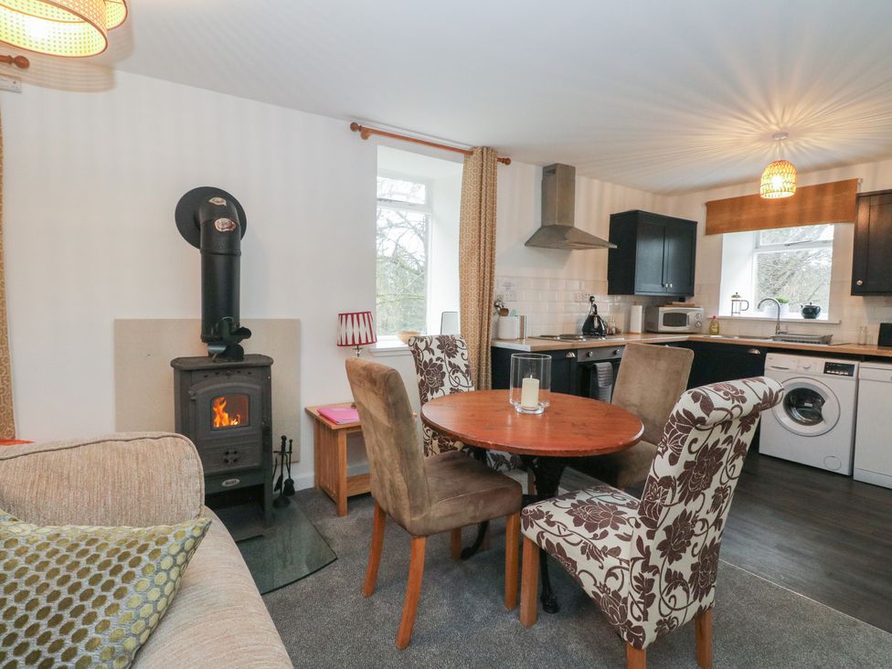 A kitchen with a table and chairs at Willow near Killean Farmhouse Cottages near Inveraray