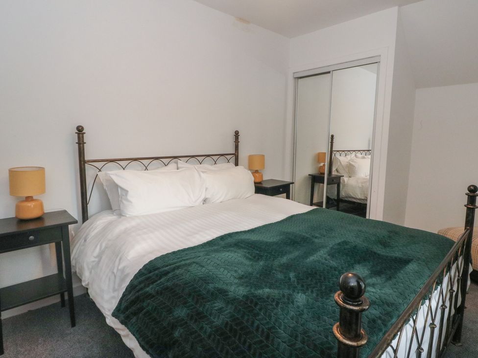 A bedroom with a bed and nightstands at Willow near Killean Farmhouse Cottages Inveraray