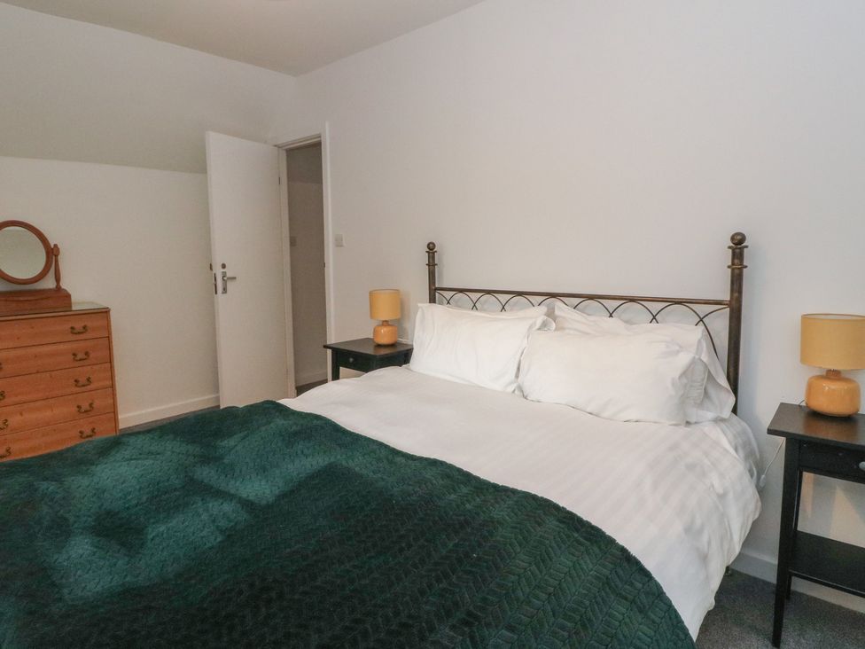 A bedroom with a bed and dresser at Willow Killean Farmhouse Cottages near Inveraray