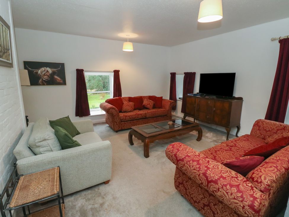 A living room with sofas and a television at Hawthorn near Killean Farmhouse Cottages near Inveraray