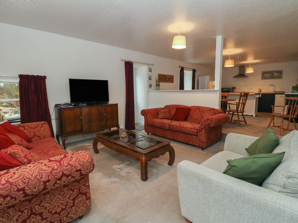 A living room with sofas and a television at Hawthorn Killean Farmhouse Cottages near Inveraray