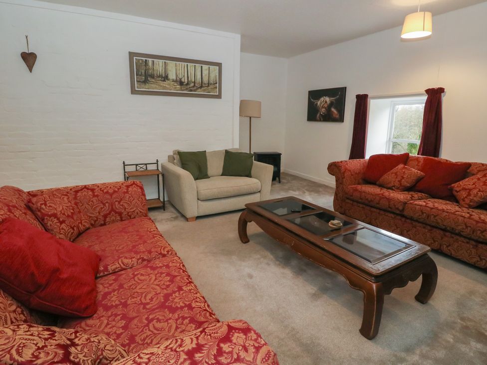 A living room with sofas and a coffee table at Hawthorn near Killean Farmhouse Cottages
