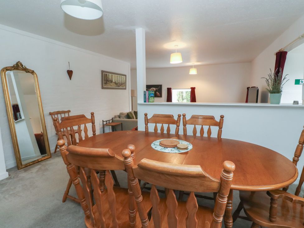 A dining room with a wooden dining table and chairs at Hawthorn near Killean Farmhouse Cottages near Inveraray