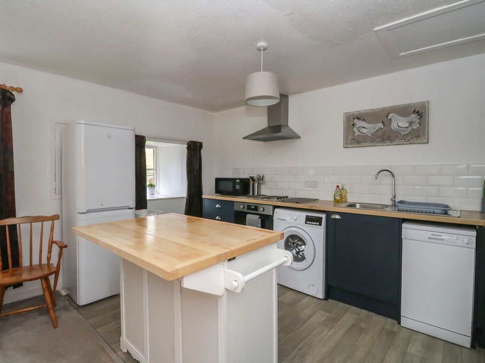A kitchen with appliances and a wooden island at Hawthorn near Killean Farmhouse Cottages Inveraray