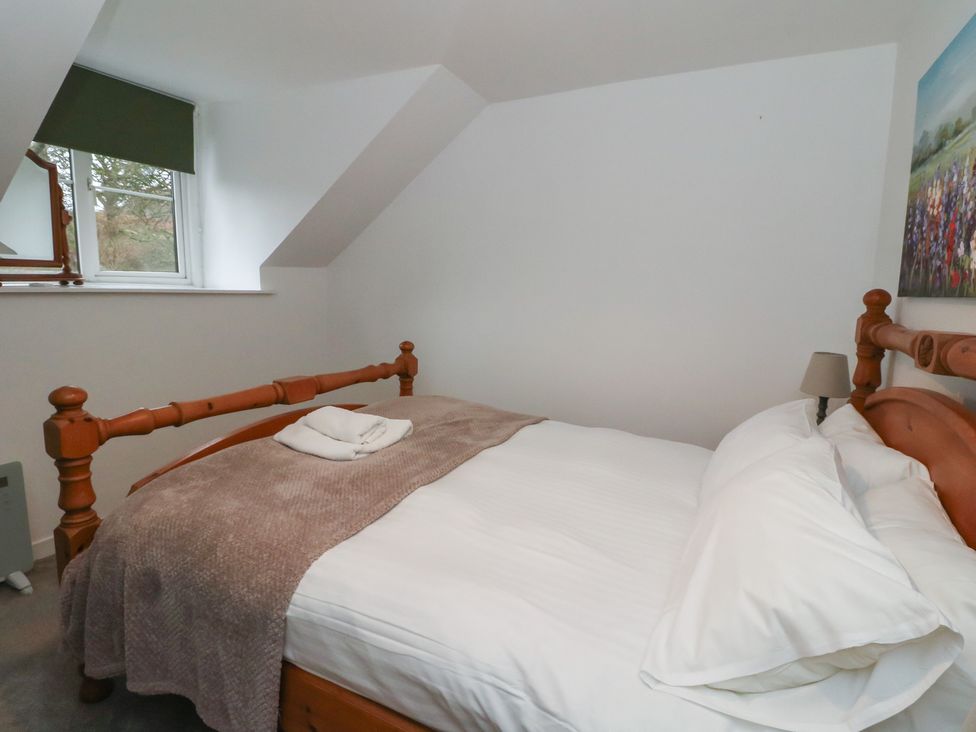 A bedroom with a bed and window at Hawthorn Killean Farmhouse Cottages near Inveraray