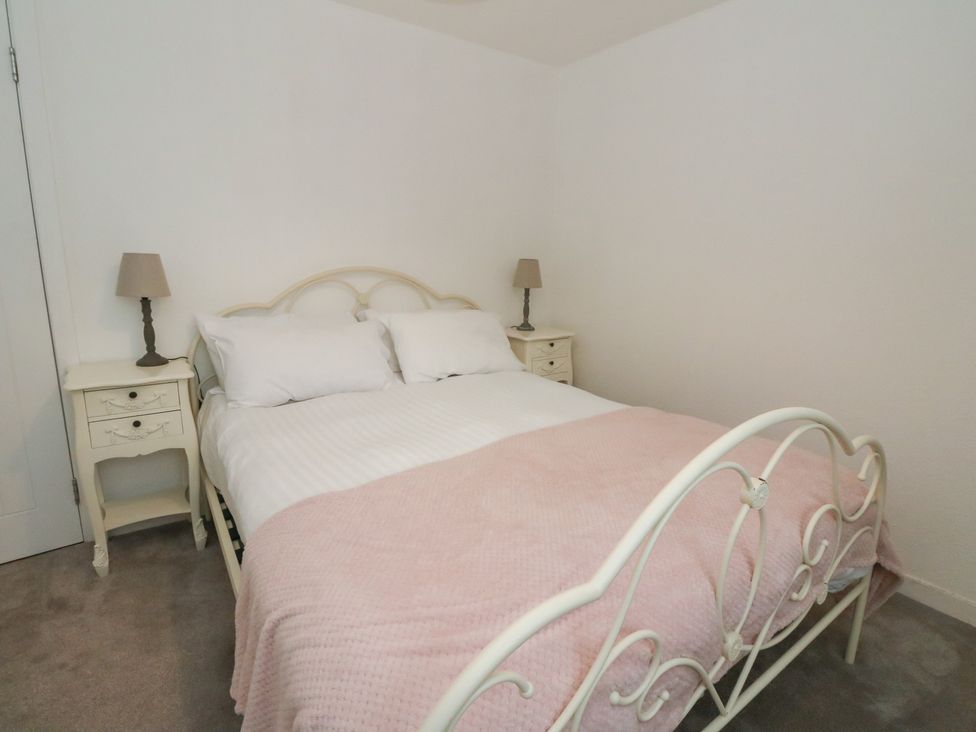 A bedroom with a bed and nightstands at Hawthorn near Killean Farmhouse Cottages Inveraray