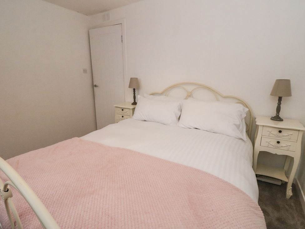 A bedroom with a bed and nightstands at Hawthorn near Killean Farmhouse Cottages