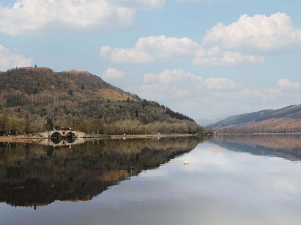 A landscape view featuring a bridge over water at Hawthorn in Killean Farmhouse Cottages near Inveraray