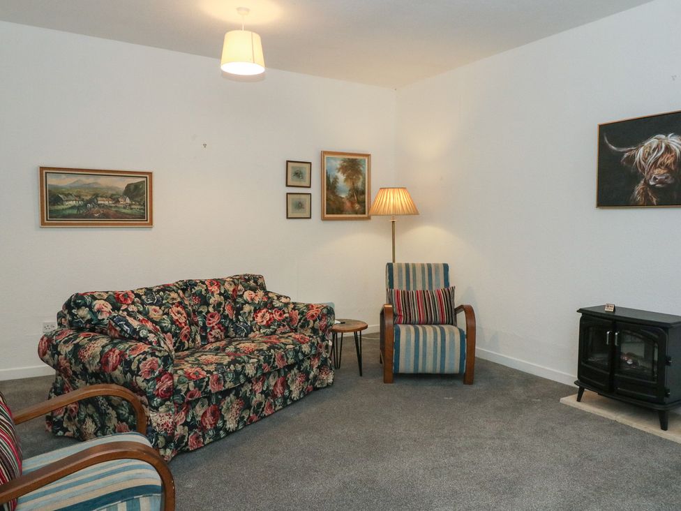 A living room with a sofa and armchair at Holly Cottage Killean Farmhouse Cottages near Inveraray