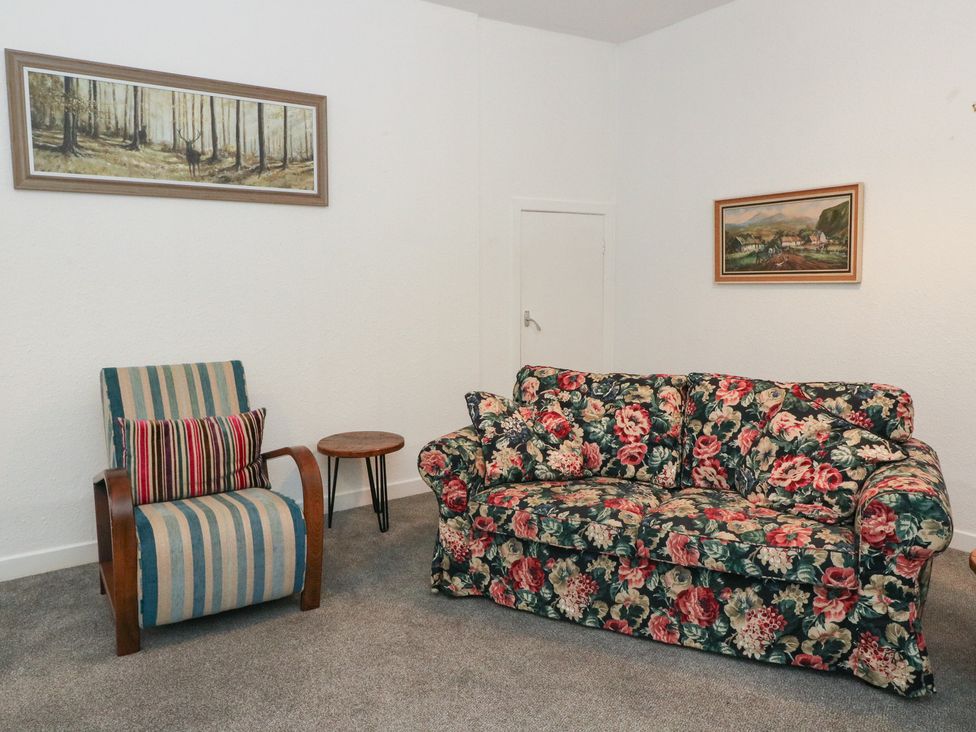 A living room with a sofa and armchair at Holly Cottage near Killean Farmhouse Cottages near Inveraray