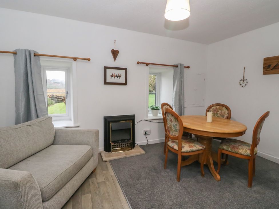 A dining room with a table and chairs at Holly Cottage near Killean Farmhouse Cottages in Inveraray