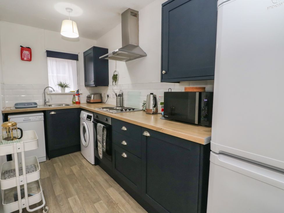 A kitchen with appliances including a fridge and stove at Holly Cottage near Killean Farmhouse Cottages