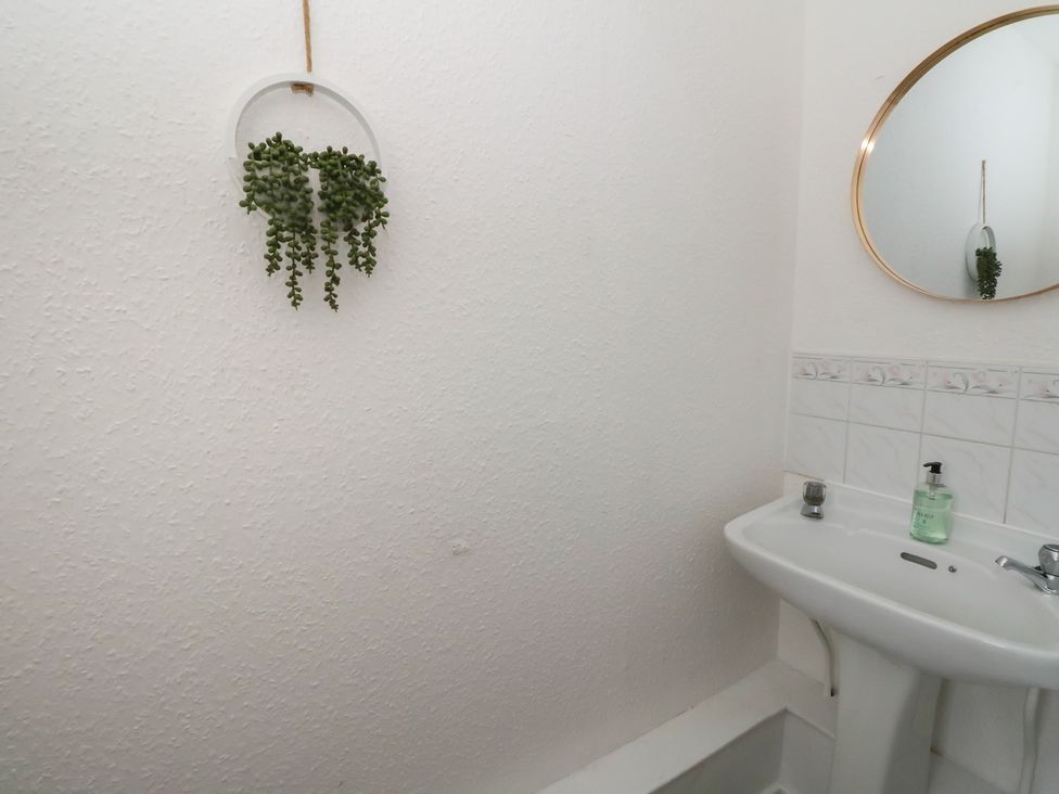 A bathroom with a sink and mirror at Holly Cottage near Killean Farmhouse Cottages near Inveraray