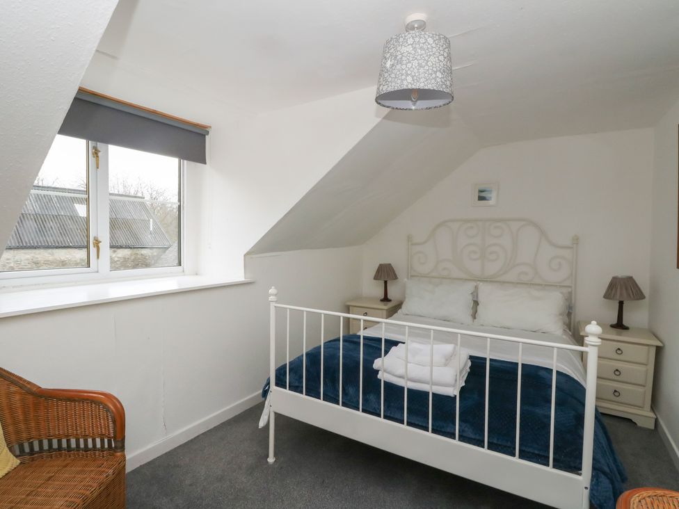A bedroom with a bed and side tables at Holly Cottage near Killean Farmhouse Cottages
