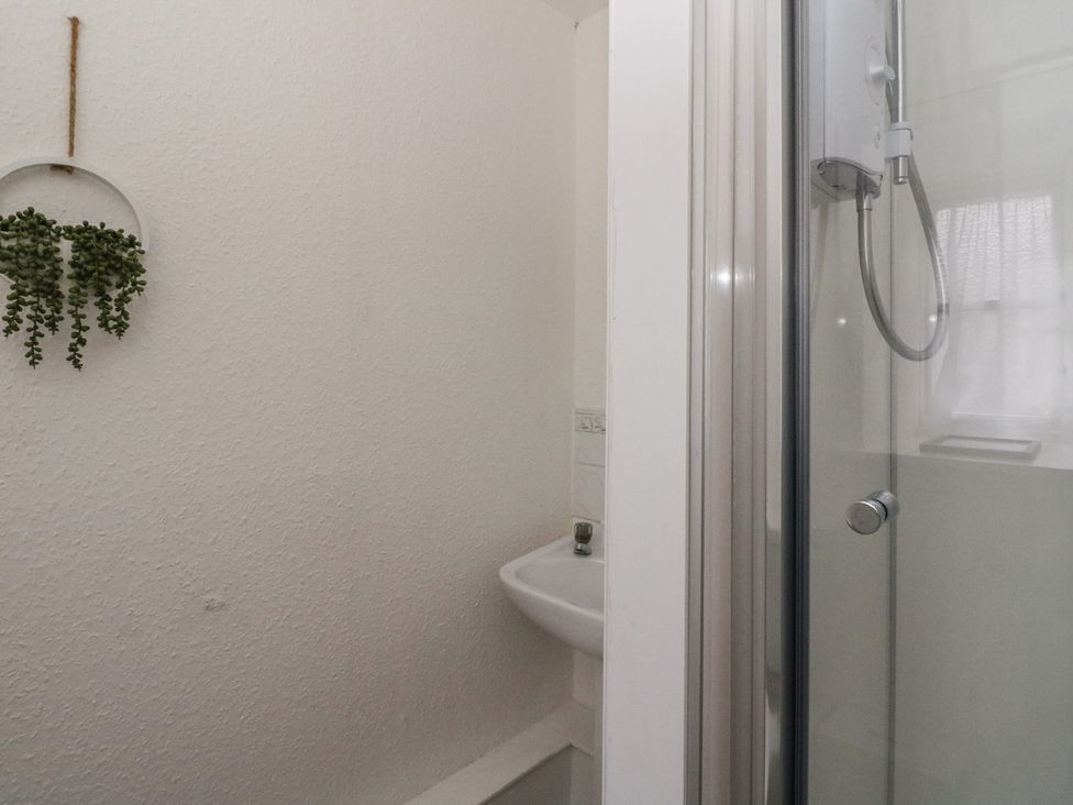 A bathroom with a shower and sink at Holly Cottage near Killean Farmhouse Cottages near Inveraray