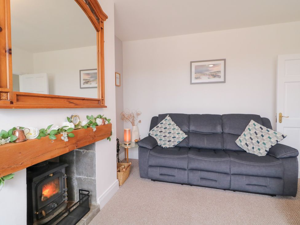 A living room with a sofa and a fireplace at Ard na Gréine in Glenties, County Donegal
