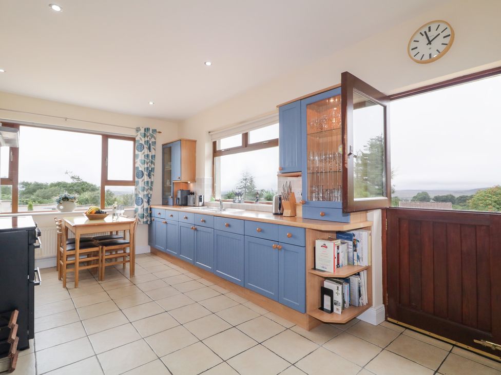 A kitchen with cabinets and a table at Ard na Gréine in Glenties, County Donegal