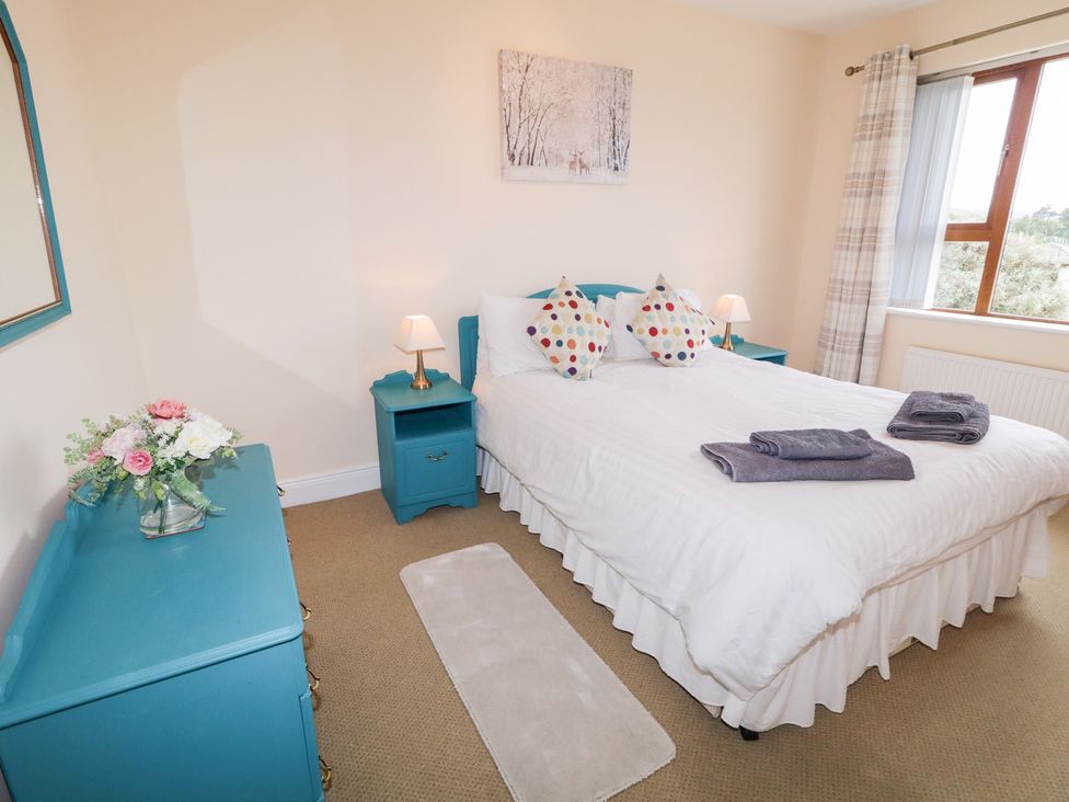 A bedroom with a bed and bedside tables at Ard na Gréine in Glenties, County Donegal