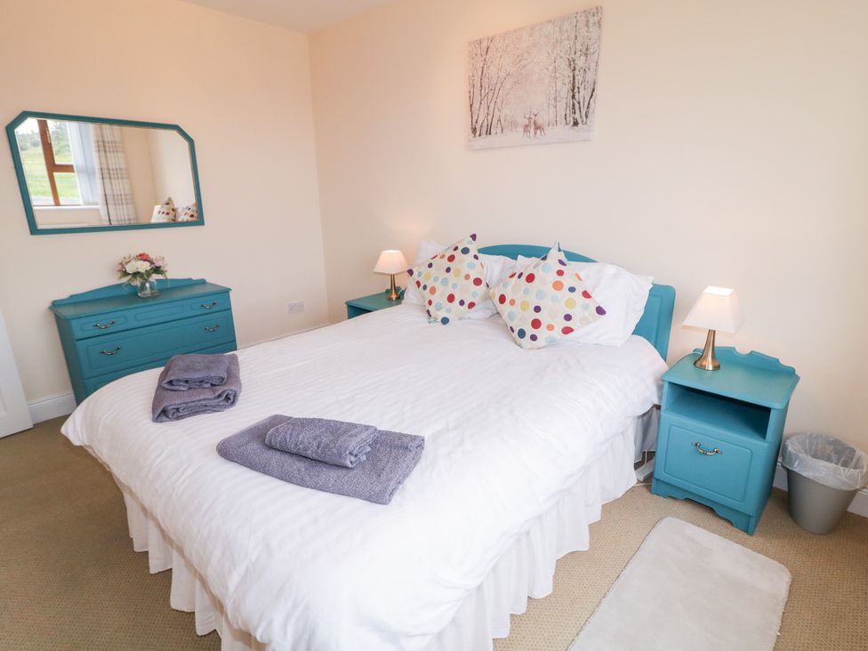 A bedroom with a bed and nightstands at Ard na Gréine in Glenties, County Donegal