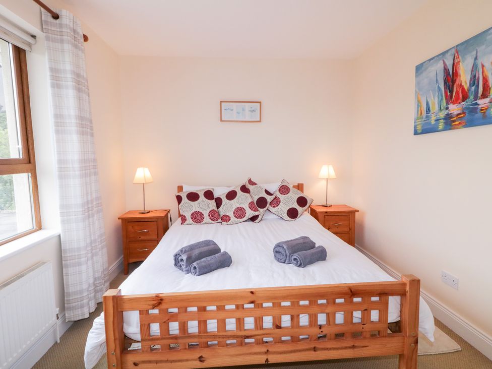 A bedroom with a bed and bedside tables at Ard na Gréine in Glenties, County Donegal