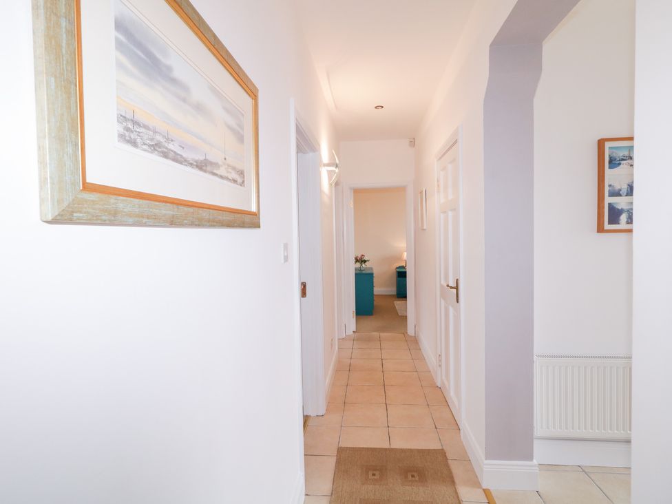 A hallway with framed artwork and a blue cabinet at Ard na Gréine, Glenties, County Donegal