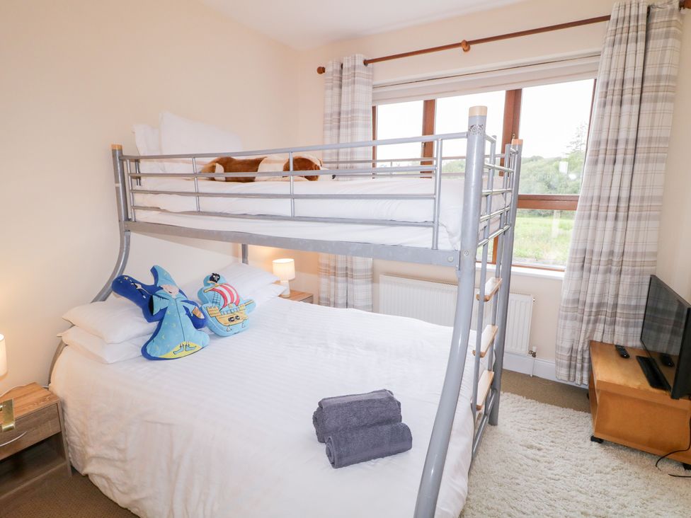 A bedroom with a bunk bed and a double bed at Ard na Gréine in Glenties, County Donegal