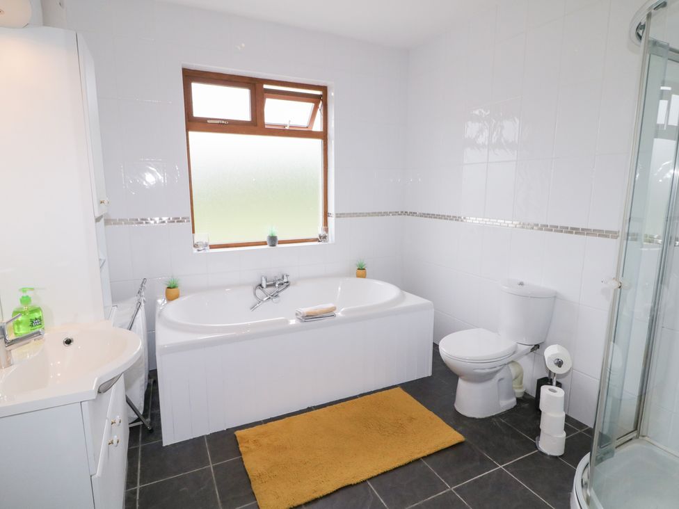 A bathroom with a bath tub, toilet and sink at Ard na Gréine, Glenties, County Donegal