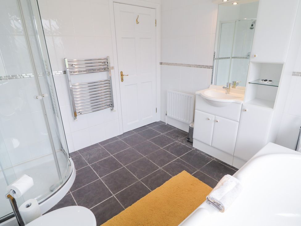A bathroom with a shower, sink, and bathtub at Ard na Gréine, Glenties, County Donegal