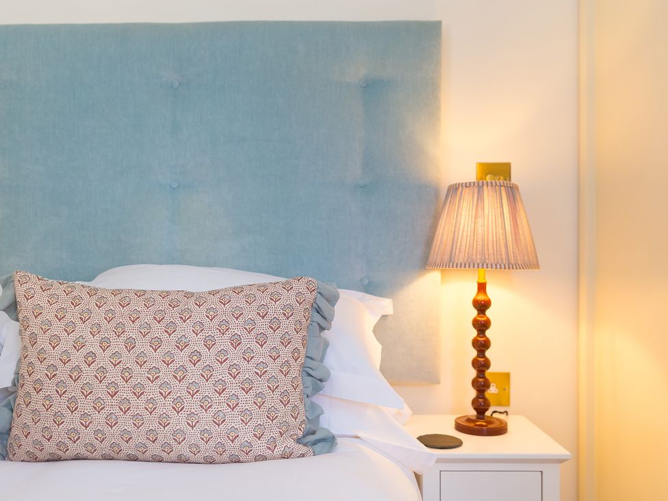 A bedroom with a bed and lamp at Scilly Stack in Penzance