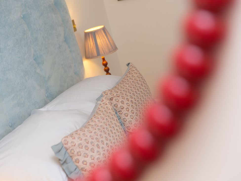 A bedroom with a bed and pillows at Scilly Stack in Penzance