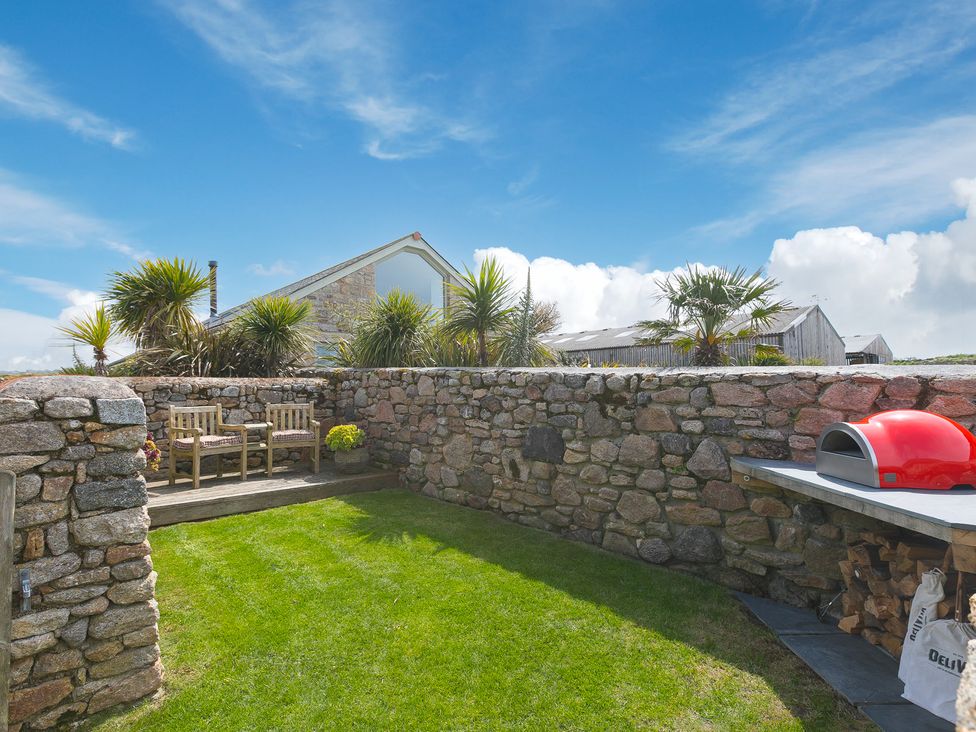 A garden with stone wall and oven at Scilly Stack in Penzance