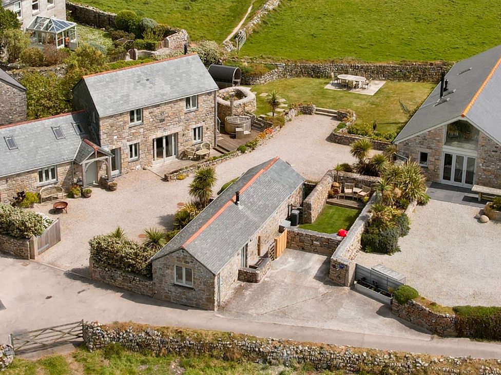 A view of multiple houses and garden area at Scilly Stack in Penzance