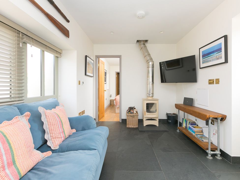 A living room with a sofa and television at Scilly Stack in St Just