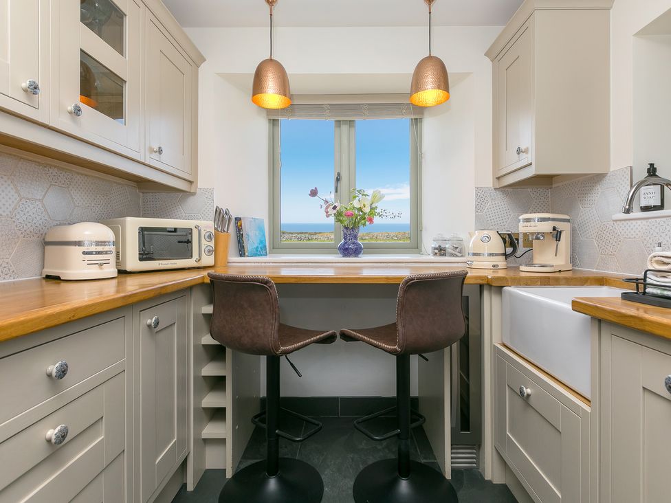 A kitchen with a sink and microwave at Scilly Stack in St Just
