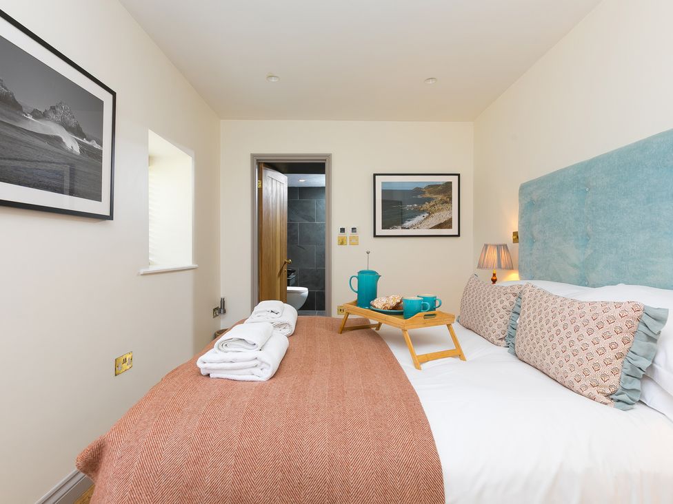 A bedroom with a bed and breakfast tray at Scilly Stack in St Just