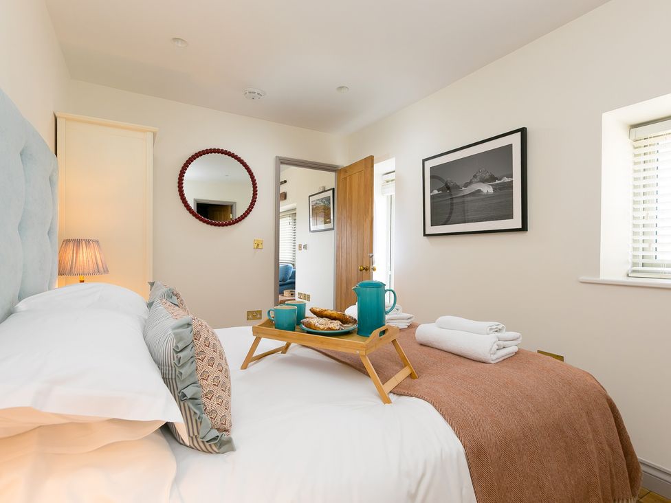 A bedroom with a bed and a tray on it at Scilly Stack in St Just