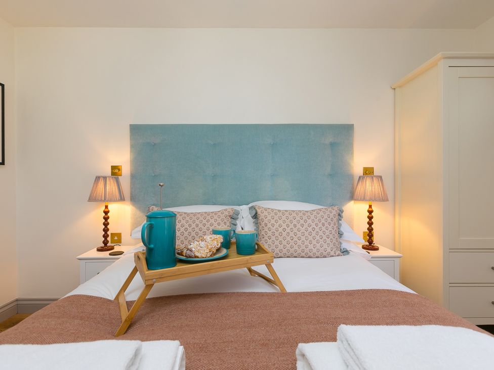 A bedroom with a bed and tray of tea at Scilly Stack in St Just