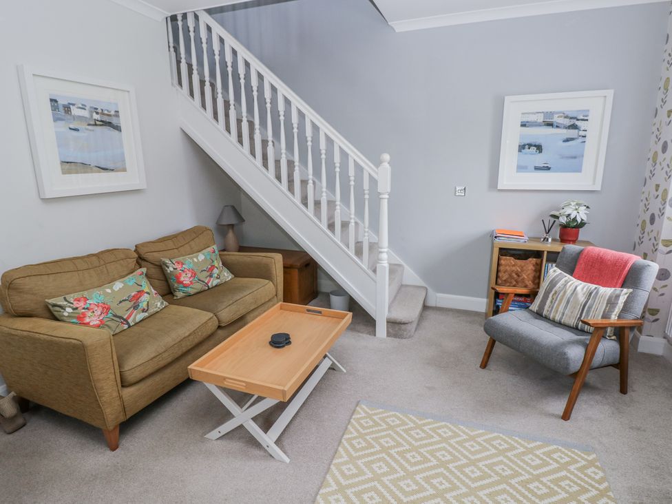 A living room with a sofa and coffee table at Crown Cottage, Penally