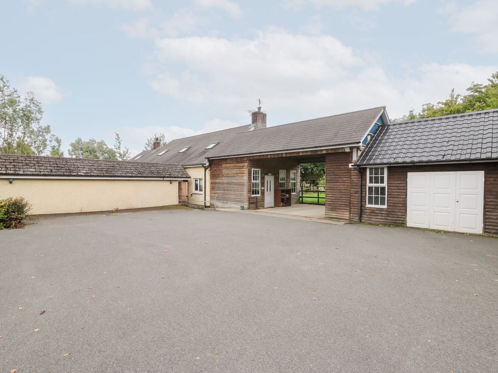 An outdoor area with a building and garage at Tynewydd Fields, Cross Inn