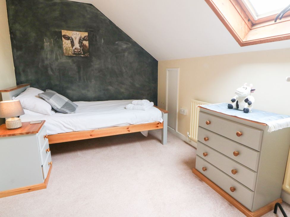 A bedroom with a single bed and a chest of drawers at Tynewydd Fields in Cross Inn