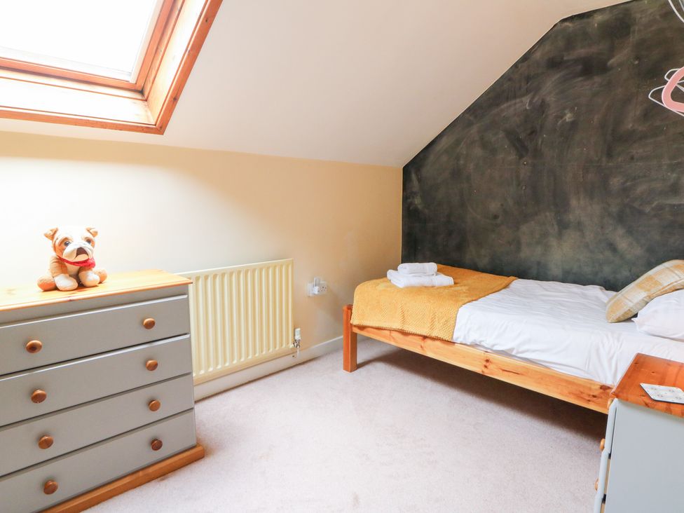 A bedroom with a bed and dresser at Tynewydd Fields Cross Inn