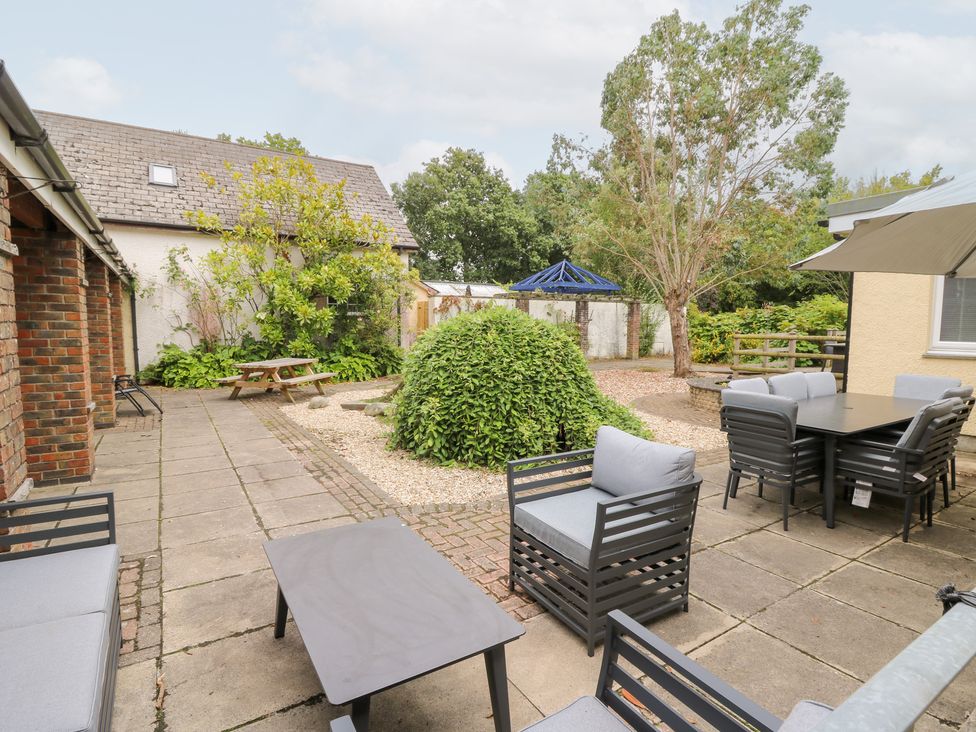 A garden with patio furniture and landscaping at Tynewydd Fields Cross Inn