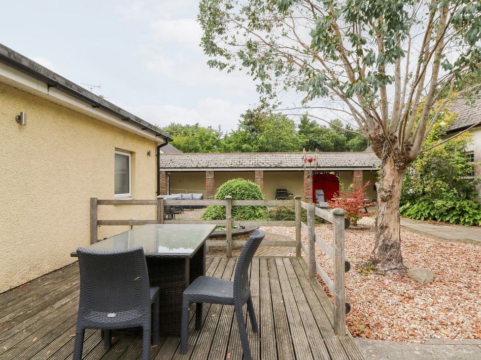 An outdoor seating area with a table and chairs at Tynewydd Fields in Cross Inn