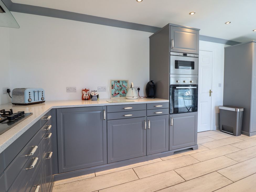 A kitchen with appliances on countertop at The Beach House in Prestatyn