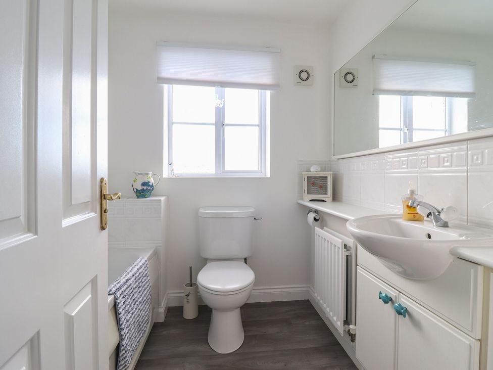 A bathroom with a sink and toilet at The Beach House in Prestatyn