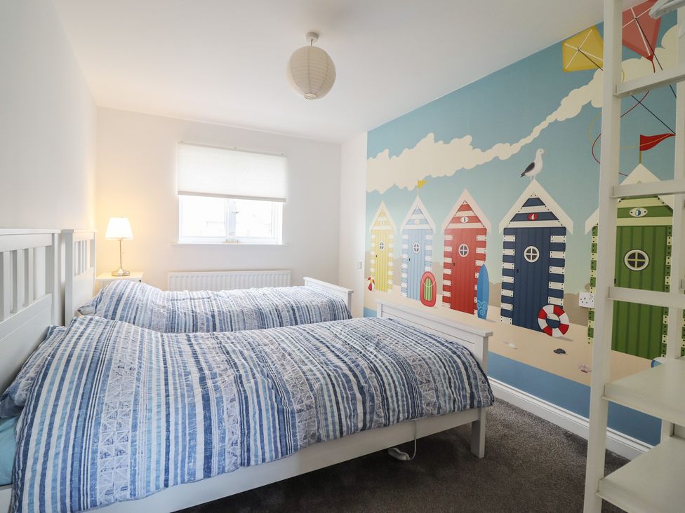 A bedroom with two beds and a wall mural at The Beach House in Prestatyn